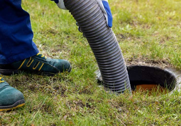 Drain cleaning technician cleaning a drain