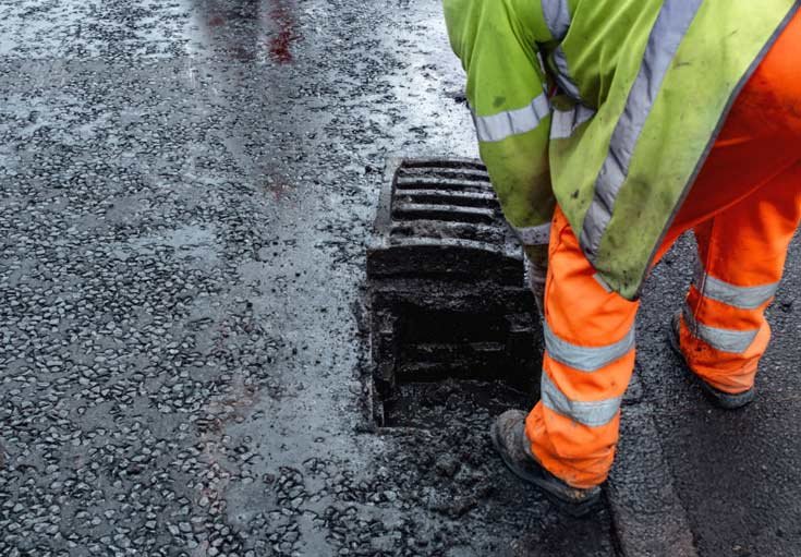 Drain Tech cleaning a drain as part of a site cleaning service